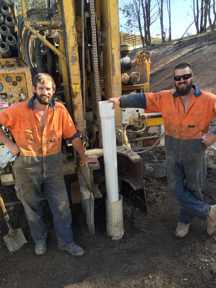 two men water bore drilling